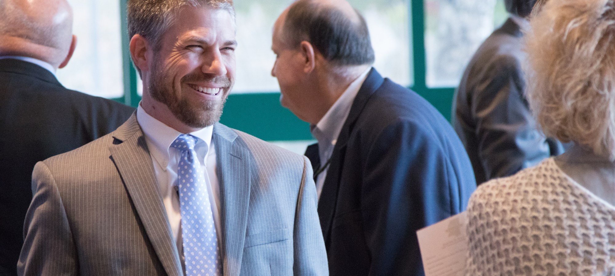 Man smiling at a reception
