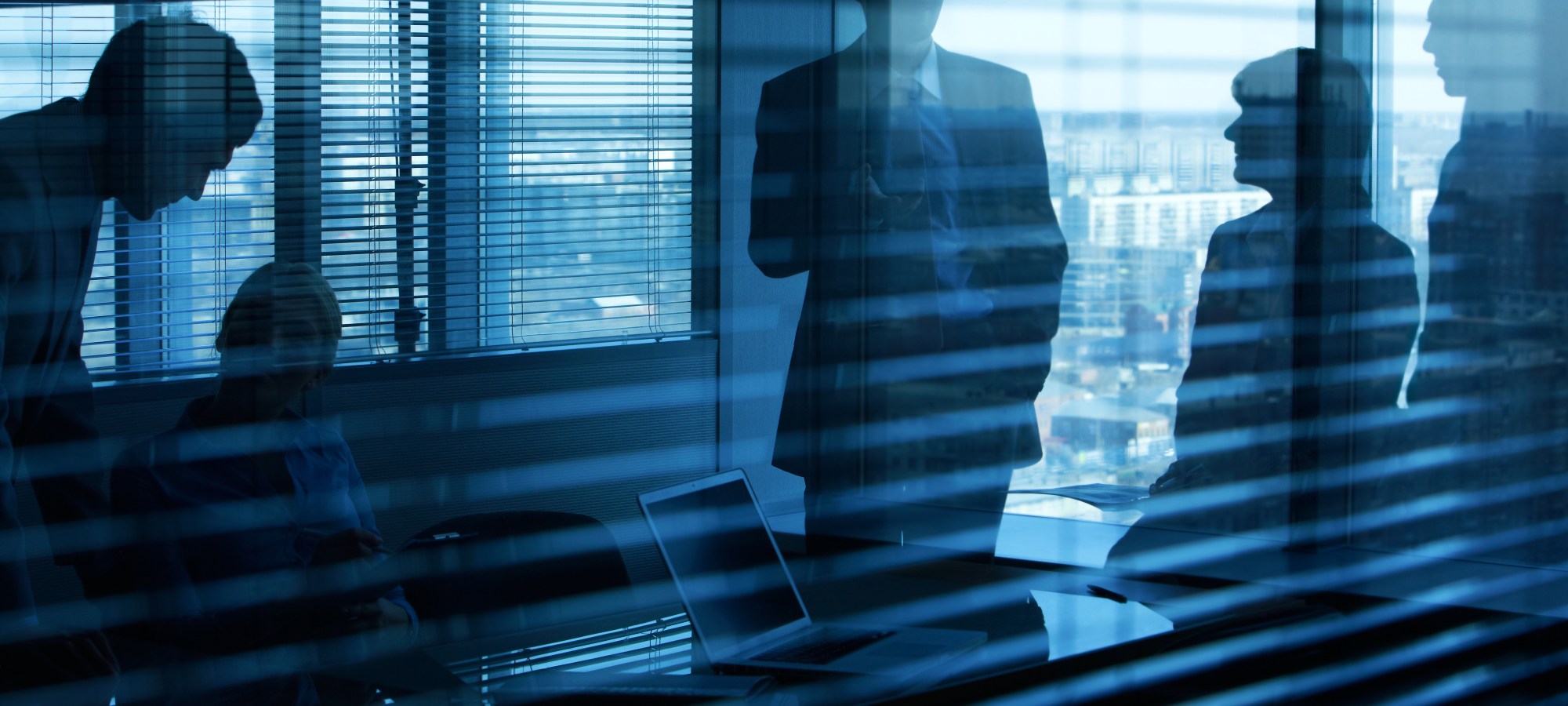 Stock photo of individuals in meeting room